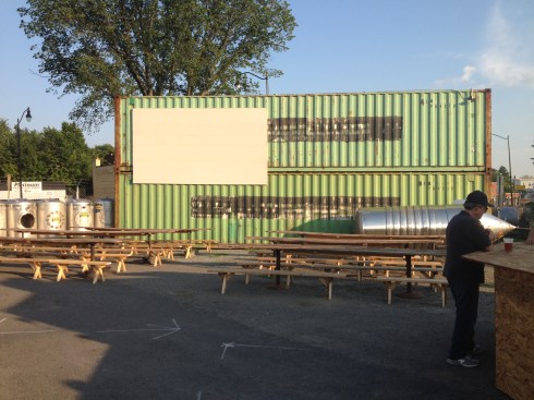 Steel Container Boxes that will House Bathrooms Inside.  Note the Large Screen that Movies will be Projected Onto.